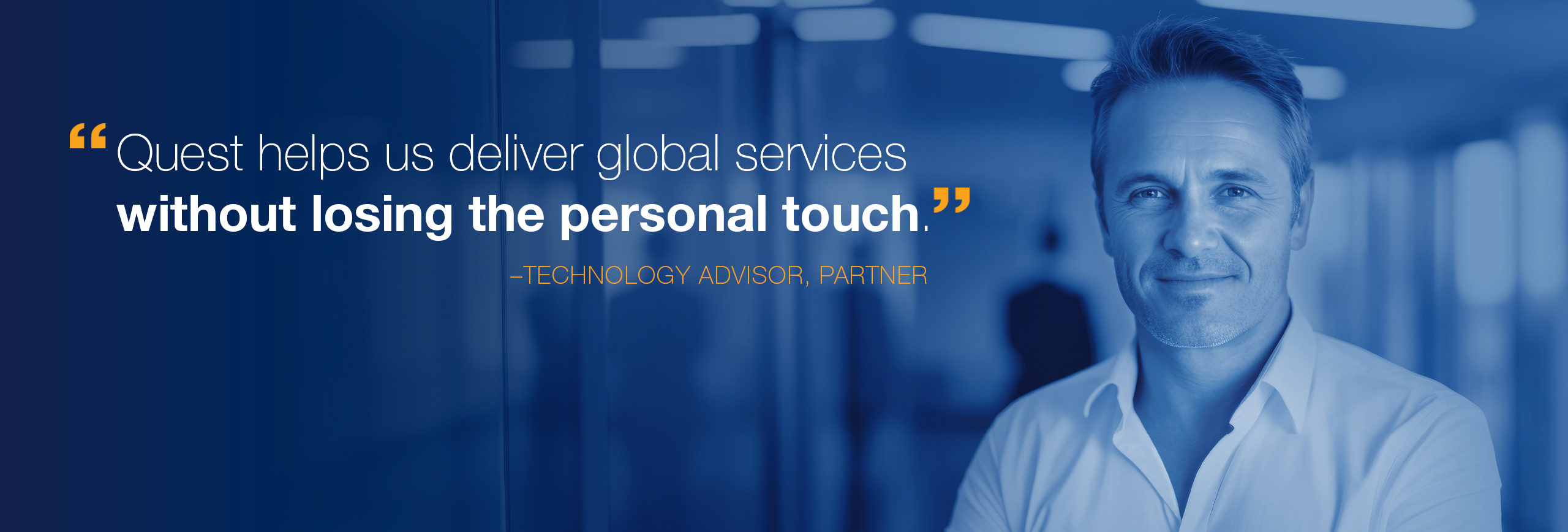 Business man standing in office area. Slide has a quote from a Quest partner: Quest helps us deliver global services without losing the personal touch.